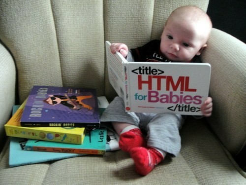 A toddler "reading" a "HTML for Babies" book