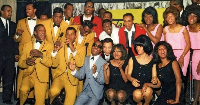 A color group photo of musical talents in the 60s
