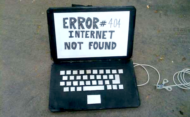 A cardboard laptop with "Error #404 Internet not found" on the screen
