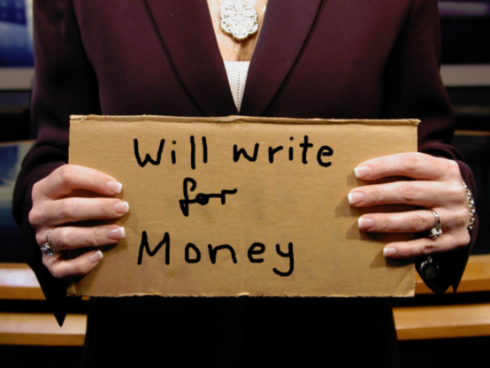 Human holding a piece of cardboard with "Will write for Money"