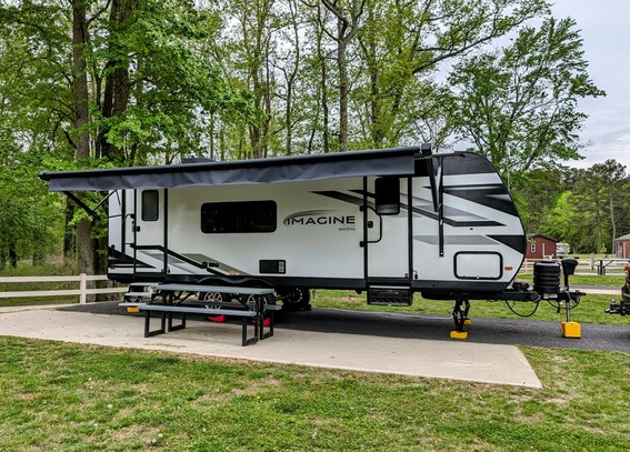 a travel trailer parked in a campsite