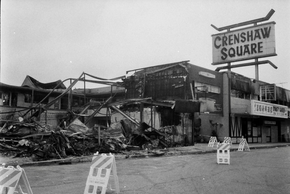 The burned remains and Large sign of Crenshaw Square, Crenshaw Blvd., in the aftermath of the LA uprising, April 29, 1992