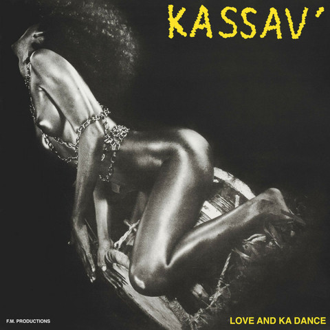 Africa - Kassav' (Love and Ka Dance)
A nude black woman, only wearing chains, sitting on a traditional drum