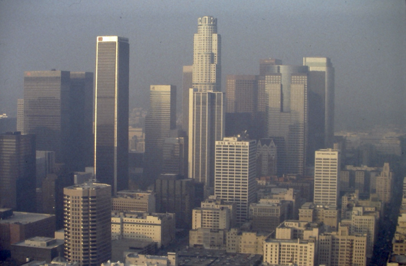 A helicopter view of downtown Los Angeles, bathed in a warm sun and that brownish haze of LA smog, 1994