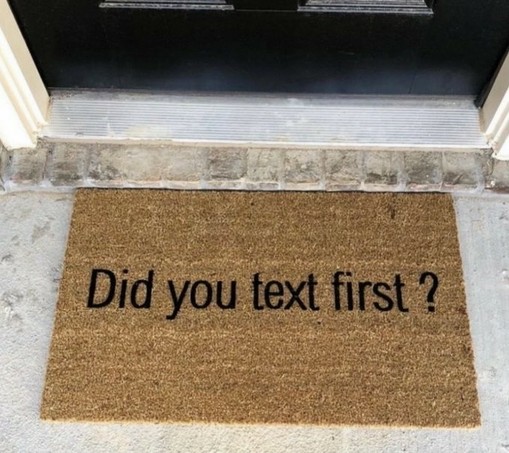 "welcome" mat in front of an exterior door that says "Did you text first?"
