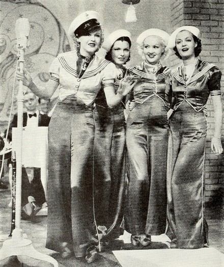 Magazine photo of four women singers in sailor-themed outfits.