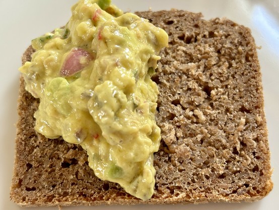 A slice of rye bread topped with savoury spread
