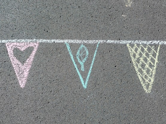 Bunting drawn on an asphalt footpath to represent a finish line.
