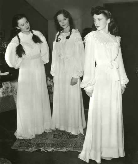 Three actresses in long white nightgowns