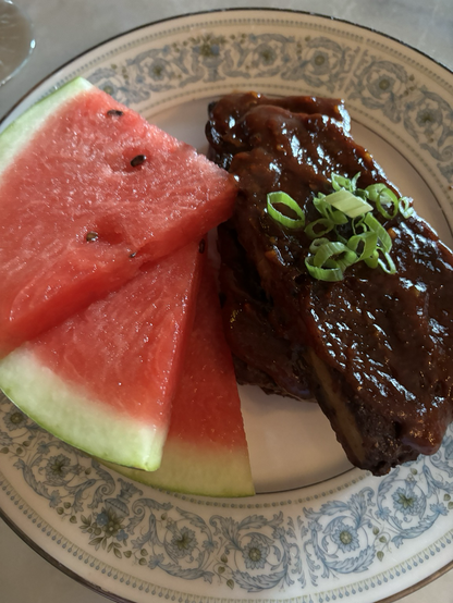 A plate of ribs and watermelon