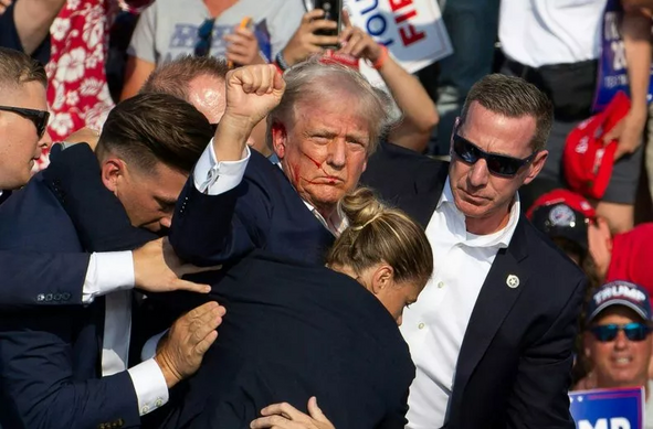 Former President Donald Trump is seen with blood on his face in Butler, Pennsylvania, on July 13, 2024. FBI Director Christopher Wray testified that Trump was either hit by a bullet or shrapnel during the attempt on his life in Butler.