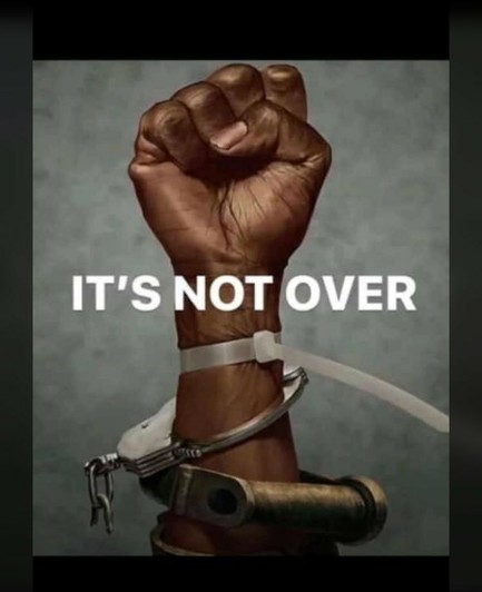It's not over
Drawing of a clenched black fist, up, with various shackles and handcuffs