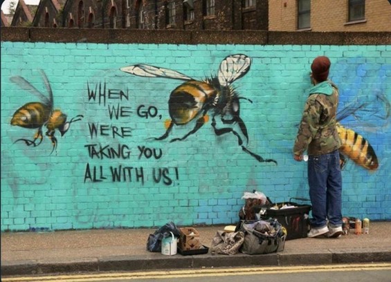 Graffiti in progress of bees on a blue wall: 