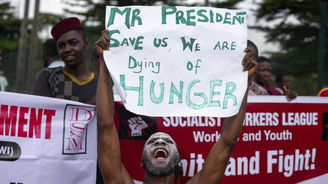 A protester showing a large piece of paper 