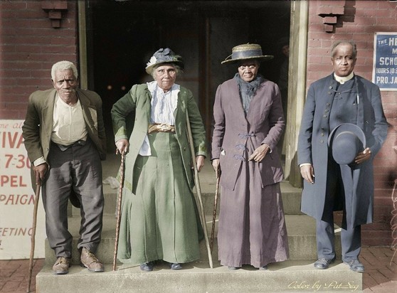 Colorized photo - 2 women in center, 1 man on each side.
3 of them need canes.
3 of them have hats (2 women, 1 man is holding it in front of him)