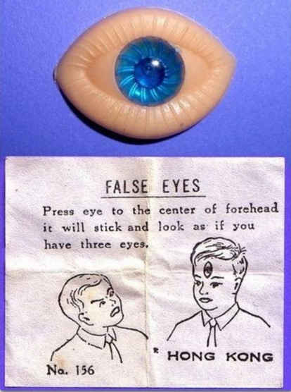 A plastic eye with a blue center at top. Below a drawing of a child with false eye on stands in front of a horrified friend.  Test says. 