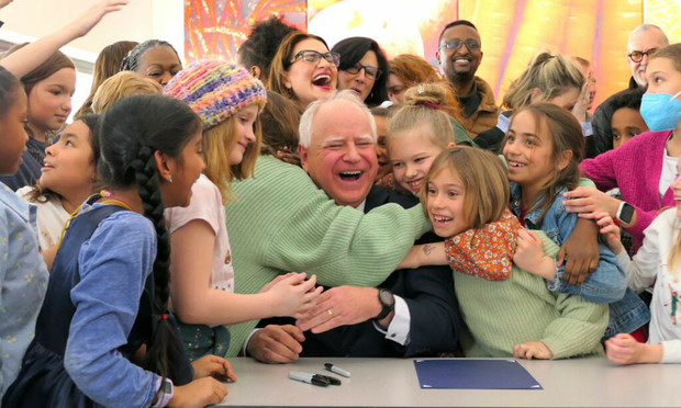 Tim Walz being hugged by schoolkids