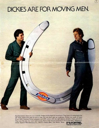Vintage ad for Dickies brand overalls. A photo of two men in denim overalls posing with a prop horseshoe that’s bigger than them. Each of the two prongs of the horseshoe has a phallic shape. The tagline reads: “Dickies are for moving men”
