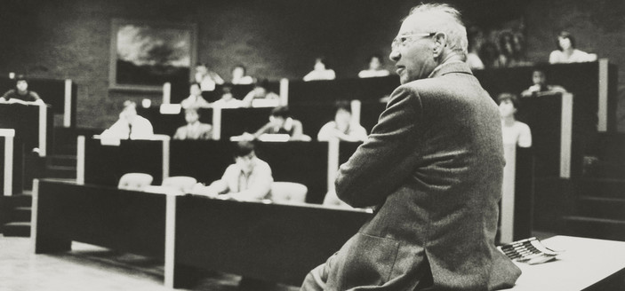 B&W photo
Peter Drucker sitting in a classroom, with students in the background