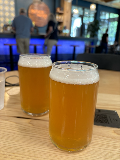 Two beers in glasses on a wooden table 