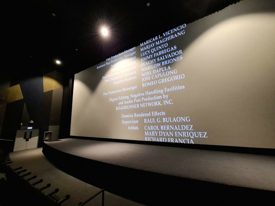 Photo of the movie screen with the credits rolling, cinema is already lit