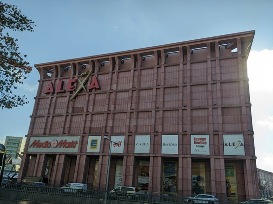 the Alexa Centre, a large, rather rectangular, gray-pinkish building. there's a big ALEXA logo on top of the façade.