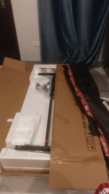Huge package of unassembled standing desk.