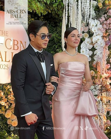 Coco Martin wearing a tux beside his wife (that he groomed) Julia Montes in a pearly pink tube gown.