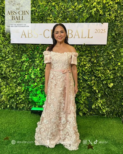 Charo Santos in a white gown with floral embellishments.