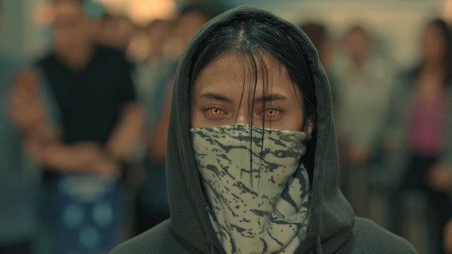 Bianca Umali wearing a mask and having glowing brown eyes in Sang'gre.