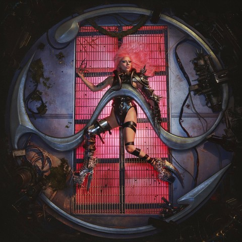 The album cover for Chromatica features Lady Gaga suspended in a futuristic, cyberpunk-inspired setting, encased within a metallic, pink-hued structure resembling a dystopian portal. She is dressed in a striking ensemble of black leather and armor-like accessories, with bold makeup and an intense gaze, embodying the album’s themes of resilience and transformation. The background is textured with industrial elements, including wires and metallic surfaces, reinforcing the album’s aesthetic of a synthetic yet emotional world.