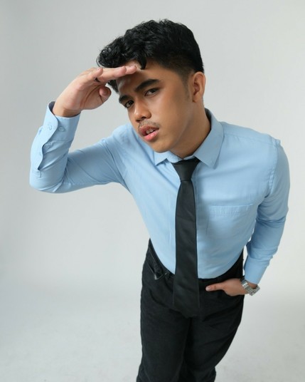 A mysterious visionary leaning forward in a light blue dress shirt and black tie, exuding sharp focus and quiet confidence. His raised hand suggests he's scanning the horizon, eyes fixed on something ahead.