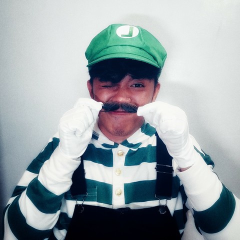 Me as Luigi from the Super Mario Bros franchise, but I hold my fake mustache to my face because I was too lazy to glue it on. It ended up looking like an aesthetic choice.