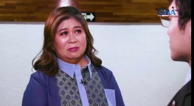 Jessica Soho holding back her laugh and slightly teary-eyed while talking to Kiko Barzaga. She's trying to stay composed but is clearly holding back her laughter.
