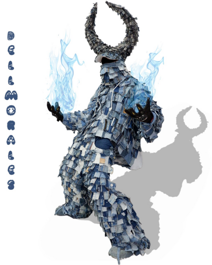 An outfit created by Dell Morales out of square denim cutouts. The top is an oversized jacket with a collar that covers the model's face up to the nose. The model wears a denim cap that's been modified to sport huge horns that curve inward to the front. Said horns are also made of denim cutouts.