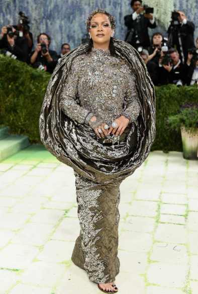 Rihanna in a sculpted silk gown with a bejeweled bodice and gilded facial accents.
