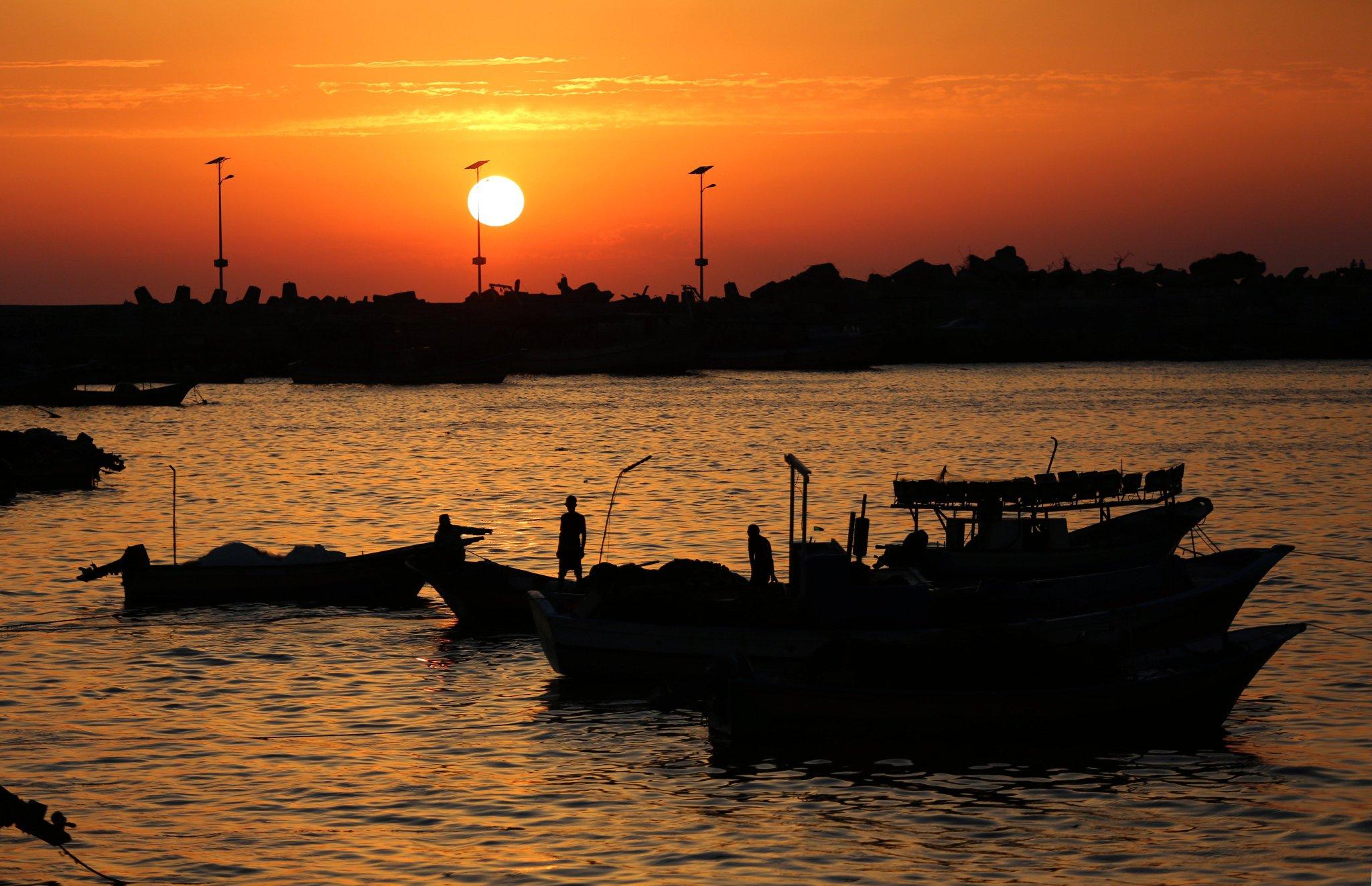 Pic from Mohammed Saber 

Super orange sky couple of small boats with fishermen on it On the water.