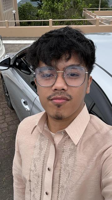 Man showing off his chestnut-colored Barong Tagalog in a selfie. Man showing off his chestnut-colored Barong Tagalog in a selfie.